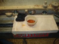 bottom of tray between wood lathe ways 