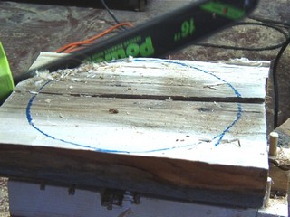  use the chainsaw to cut off the corners of the half log