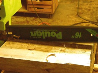 cuttin the half log down the center with the chain saw